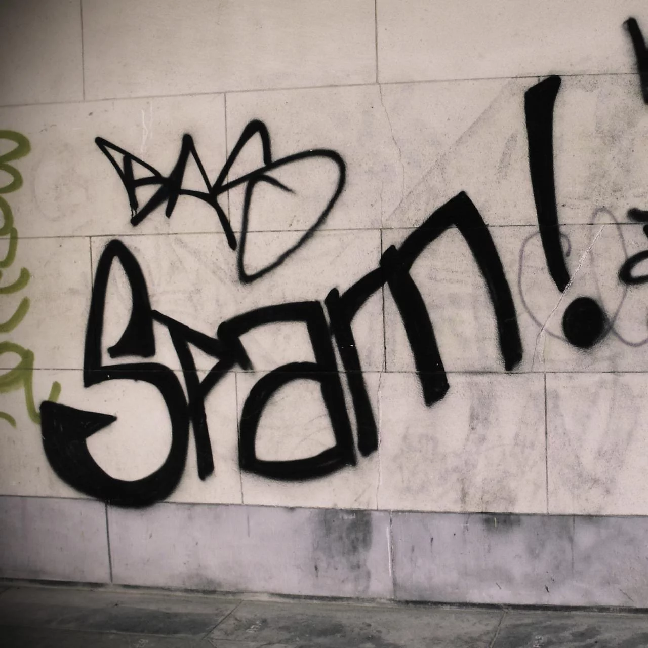 Spam spelled out in graffiti on a wall